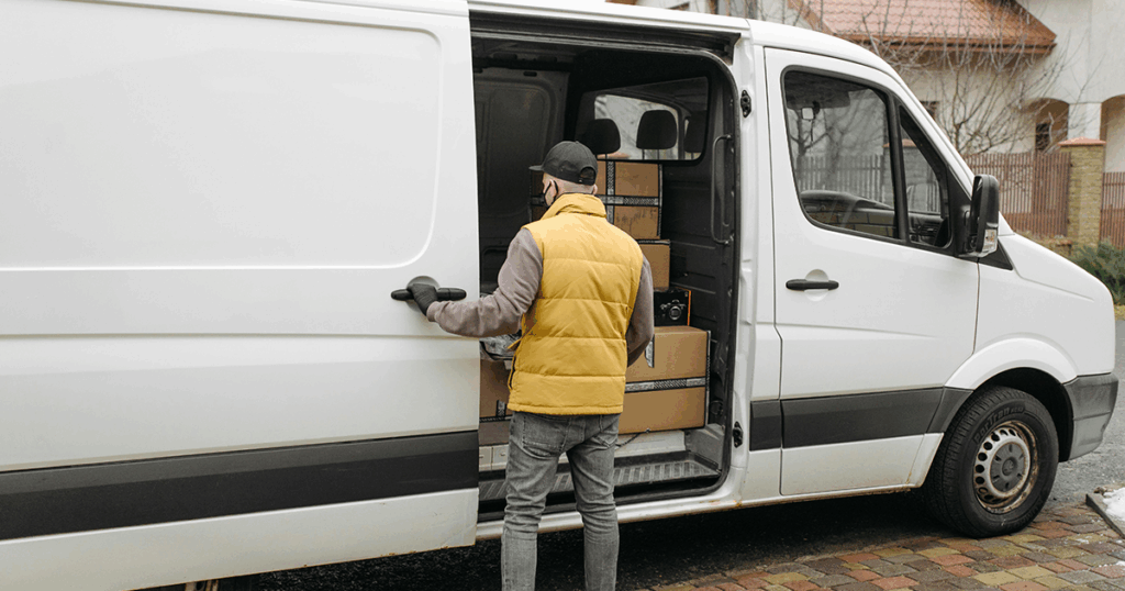 A man checking the stock in his van.