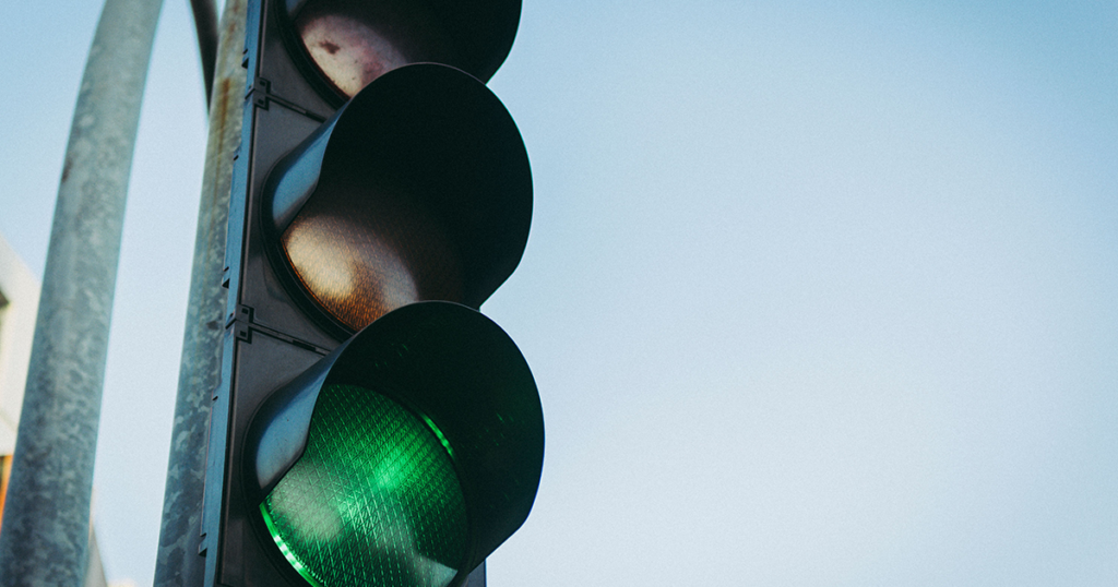 A set of traffic lights. The lights are on green
