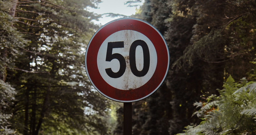 A 50mph sign in a shaded area
