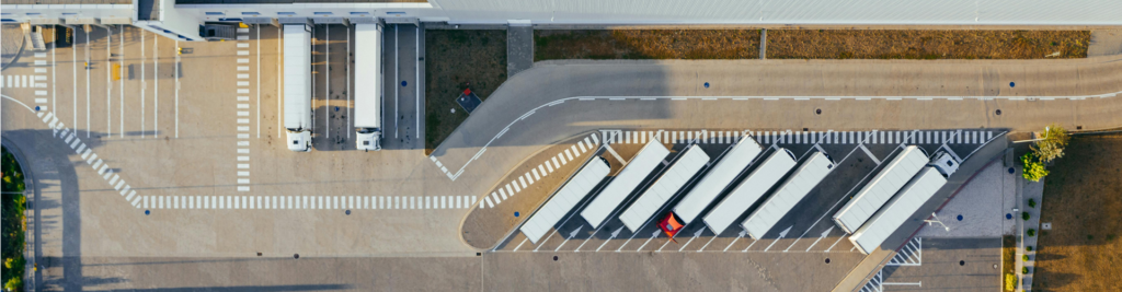 Aerial view of truck station with trucks parked-up.